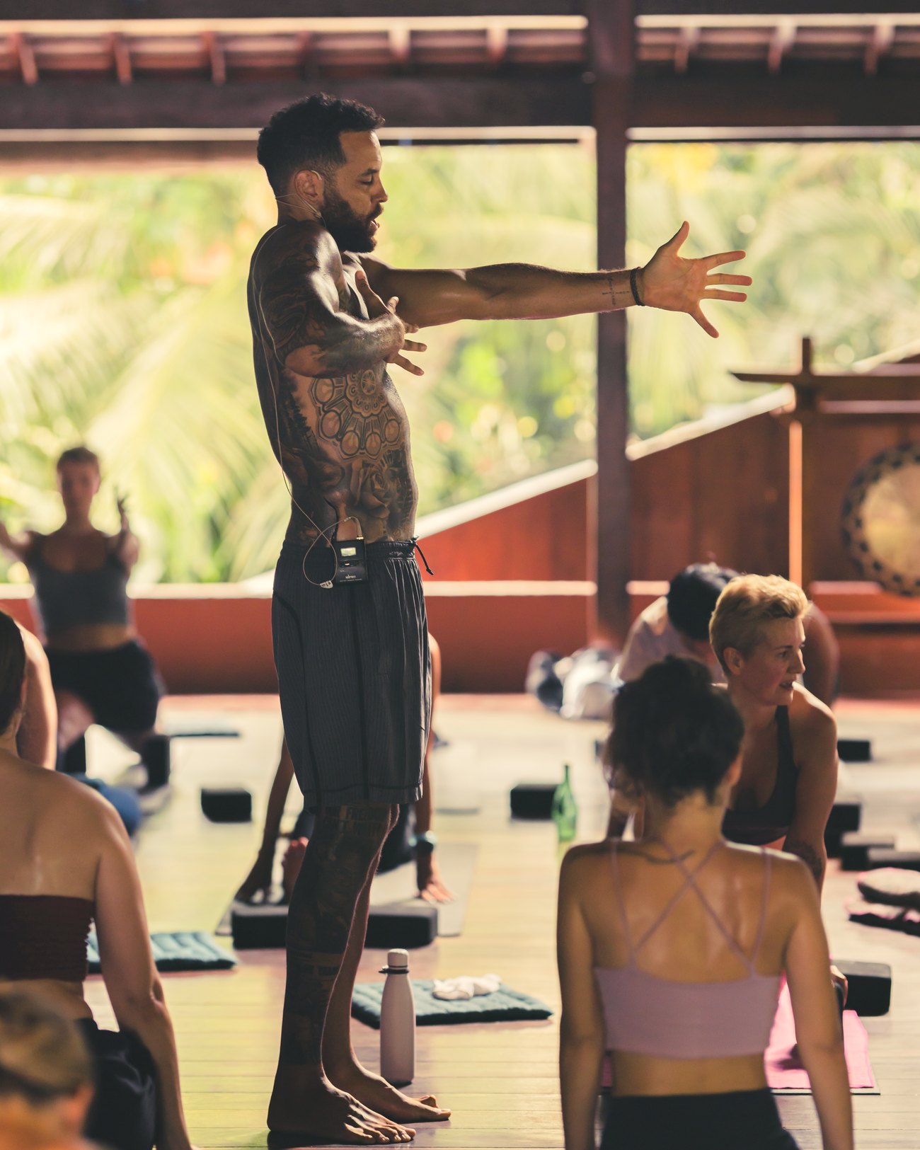 Chris Walker teaching, arm extended, reading the room mid-class