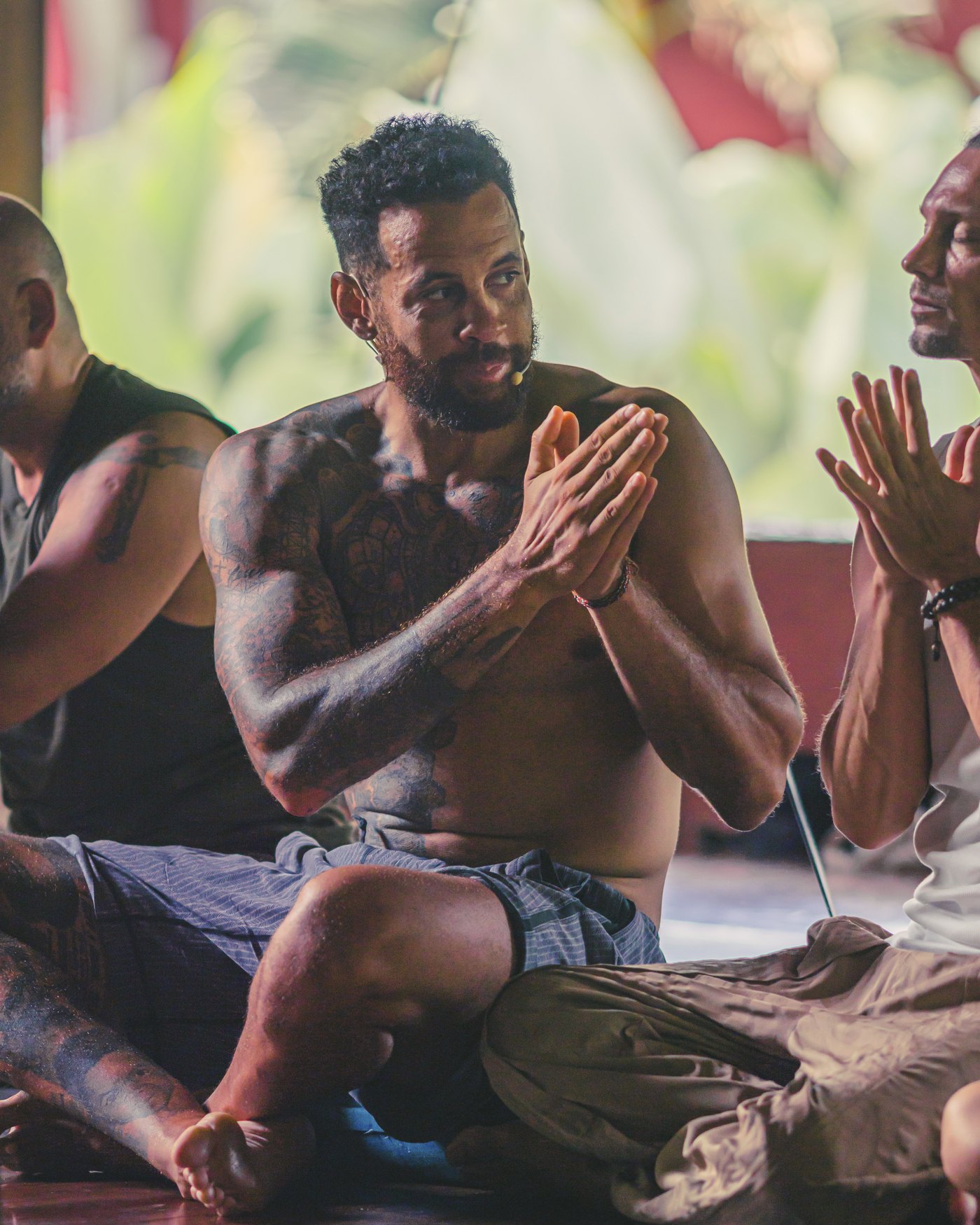 Chris Walker seated with the training circle, hands at heart