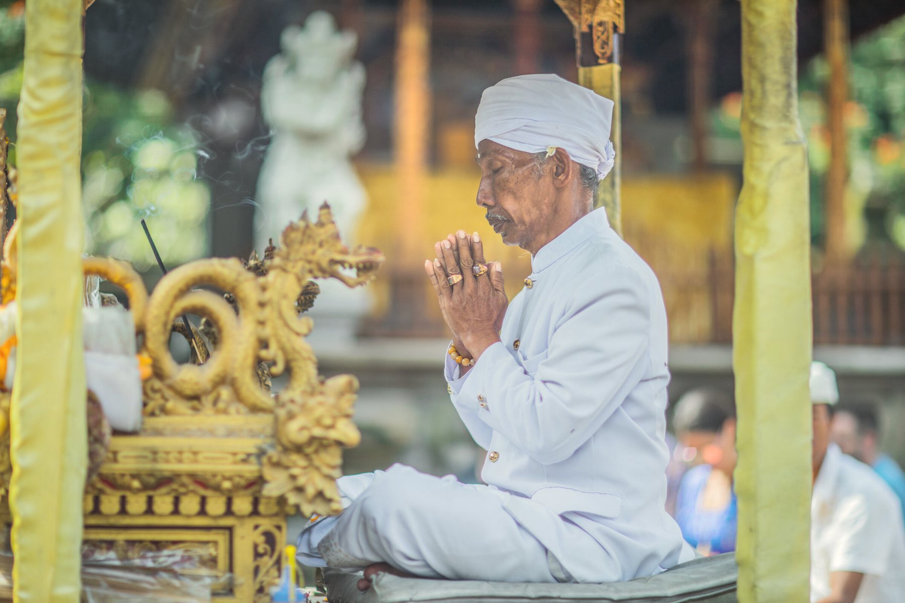A Balinese priest in prayer at the water temple