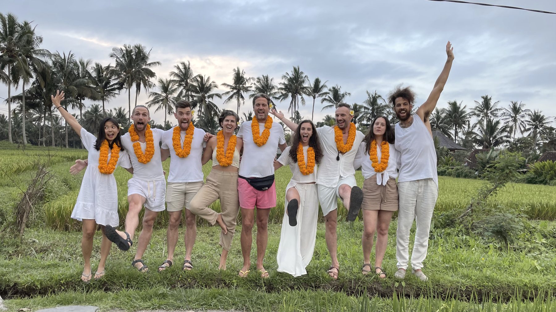 Graduates of the training celebrating in the rice fields