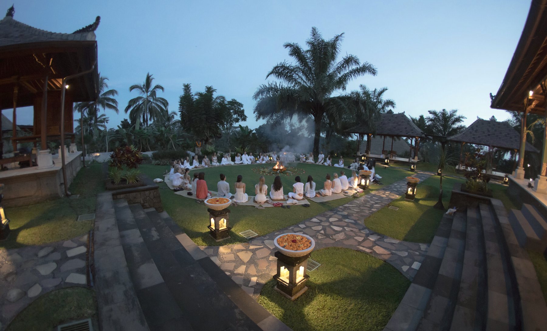 The training circle gathered around a fire at dusk